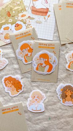 several stickers on a sheet of paper with orange and white designs in the shape of mermaids