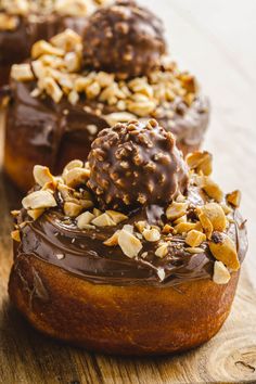 chocolate covered donuts with nuts on top