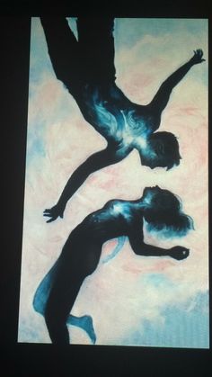 two people standing in the middle of a painting