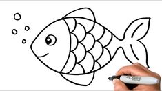 a person drawing a fish with a marker