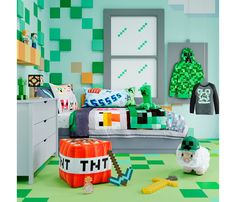 a bedroom decorated in green and white with legos on the walls, bedding and rugs