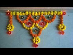 an arrangement of flowers and beads on the wall