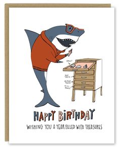 a birthday card with a shark wearing sunglasses and an orange shirt, standing in front of a desk