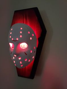 a red light that is on the wall next to a white object with holes in it