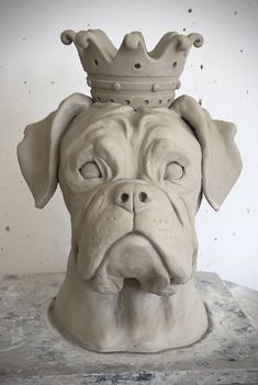 a statue of a dog with a crown on top of it's head is shown