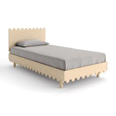 a bed with scalloped headboard and foot board, made from solid wood