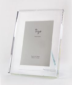 an empty glass frame with a pen on the bottom and a white background behind it