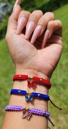 a woman's hand with three bracelets on it