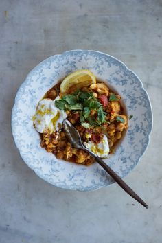 two bowls filled with food on top of a table