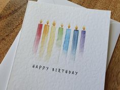 three birthday cards with watercolor candles on them