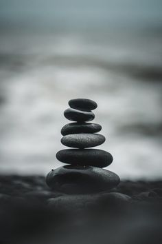 rocks stacked on top of each other in front of the ocean