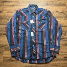 This Vintage Wrangler Shirt Is A Must-Have For Any Fashion-Savvy Individual. With Its Black Pearl Snap Stripe And Cowboy Cut Design, It Is Perfect For Any Occasion, From Casual Outings To Workwear To Cocktail Parties. Made From A Blend Of Polyester And Cotton, This Shirt Is Machine Washable And Features Long Sleeves And A Point Collar. It Also Has Pockets For Added Convenience. The Shirt Is Available In Size 16 1/2-35 And Has A Regular Fit. It Is Suitable For All Seasons, From Winter To Summer T Western Style Black Shirt For Ranch, Western Black Shirt For Ranch, Multicolor Cotton Western Shirt, Western Rodeo Shirts Button Up, Wrangler Retro Shirts, Wrangler Pearl Snap Shirt, Wrangler Cowboy, Wrangler Shirt, Wrangler Cowboy Cut