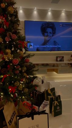 a christmas tree in front of a flat screen tv