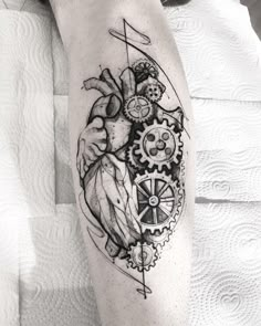 a man's arm with a clock and gears tattoo on it