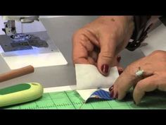 a woman is using scissors to cut fabric