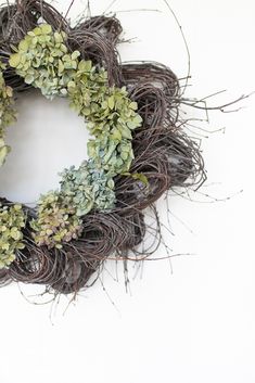 a wreath made out of twigs and plants