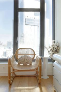 a chair sitting in front of a large window