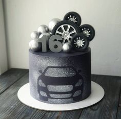 a car themed birthday cake with wheels and snowflakes on the top is shown