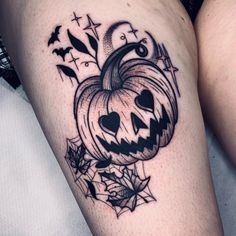 a black and white photo of a pumpkin tattoo