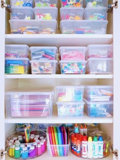 an organized closet filled with lots of crafting supplies and storage bins on top of shelves