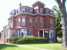 an old red brick building with many windows and balconies on the second floor