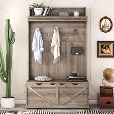 a wooden cabinet with some towels hanging on it's sides and a potted cactus in the corner