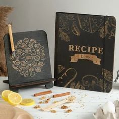 a recipe book sitting on top of a table next to some lemons and spices