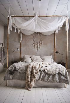 an old photo of a bed with white sheets and blankets on the headboard is shown