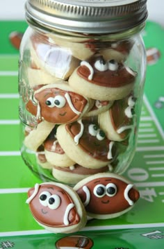 cookies in the shape of footballs are sitting in a jar