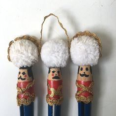 three wooden nutcrackers with white fur on them