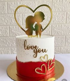 there is a cake that has two people on it and the words love you are spelled in gold