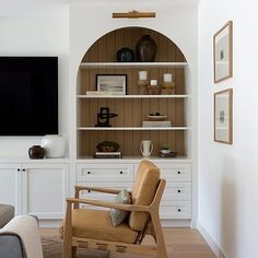 the living room is clean and ready to be used as a media center or office