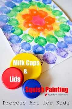 two colorful buttons sitting on top of a piece of paper with the words milk caps and lids