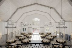 an empty banquet hall with tables and chandeliers