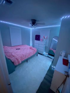 a bed room with a neatly made bed and lights