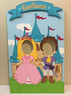 a cardboard cutout of a princess and prince standing in front of a castle