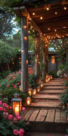 an outdoor walkway with lanterns and flowers