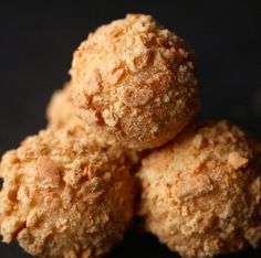 three balls of food sitting on top of each other in front of a black background