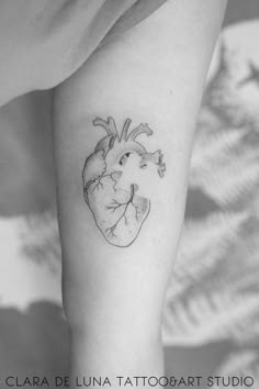 a black and white photo of a heart tattoo