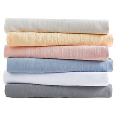 four sheets stacked on top of each other in different colors and sizes, all folded up