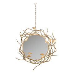 a round mirror hanging from a chain with gold leaves on it and branches in the foreground