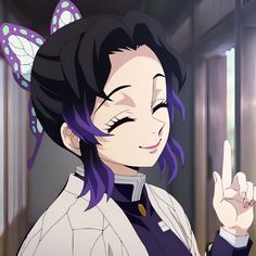 a woman with purple hair and butterfly ears pointing to the side while standing in front of a window