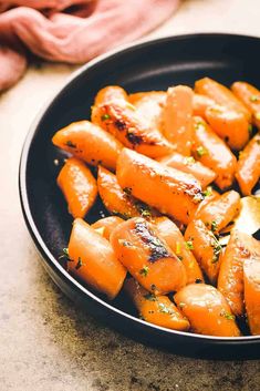 cooked carrots in a skillet ready to be eaten