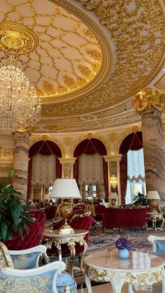 an ornately decorated living room with chandelier and couches