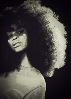 a black and white photo of a woman with an afro