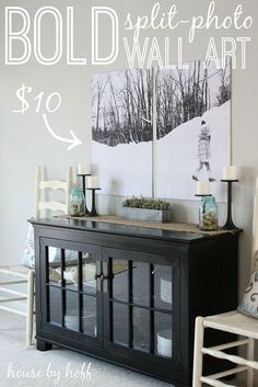 a black buffet table with two pictures on the wall above it and a chair next to it