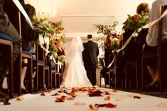 the bride and groom are walking down the aisle