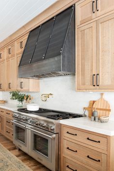 a kitchen with wooden cabinets and stainless steel appliances