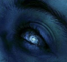 an eye is shown in the dark blue light