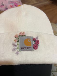 a white beanie with flowers on it